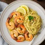 Shrimp scampi recipe with pasta on wooden table