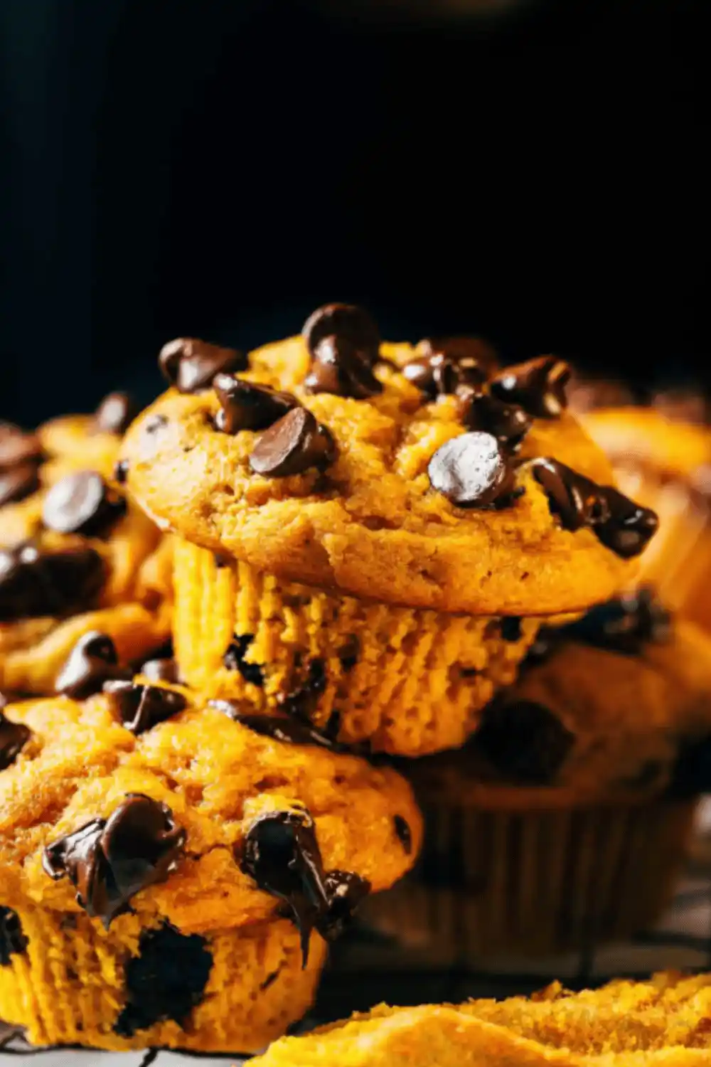 Close-up of pumpkin chocolate chip muffins showing the texture and chocolate chunks inside