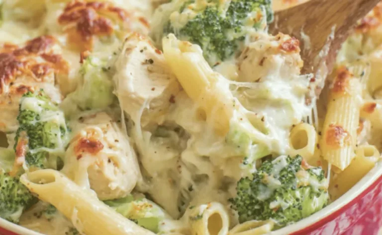 golden cheesy chicken broccoli pasta bake in a 9×13 pan just out of the oven