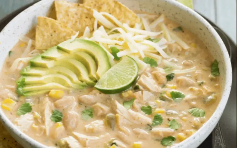Bowl of creamy white chicken chili topped with cilantro and shredded cheese