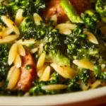 Plate of Chicken Sausage and Broccoli Orzo with fresh herbs