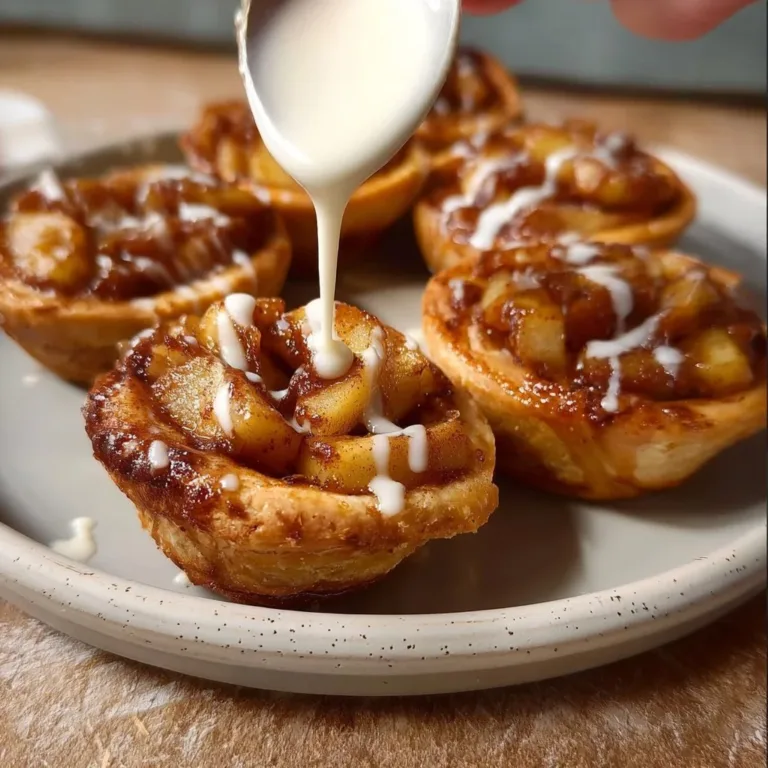Cinnamon Roll Apple Pie showcasing a golden crust and cinnamon swirl topping
