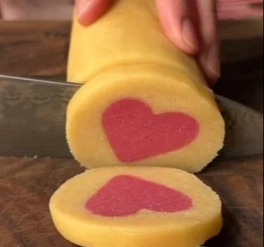 Heart-shaped slice and bake cookies ready for baking and decoration.
