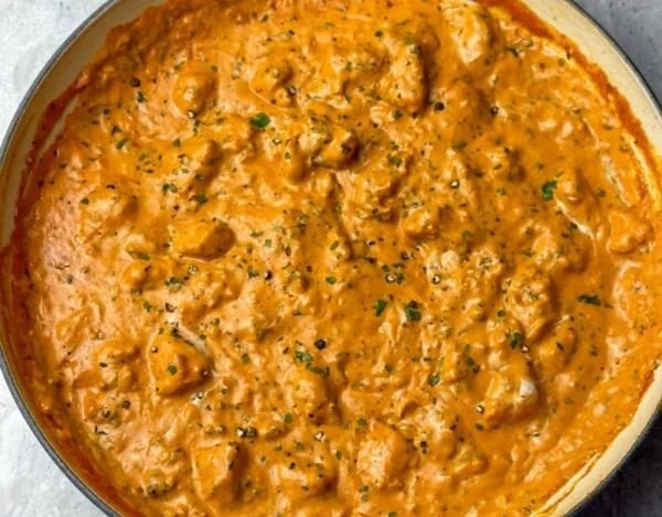 Delicious homemade butter chicken served with rice and naan.