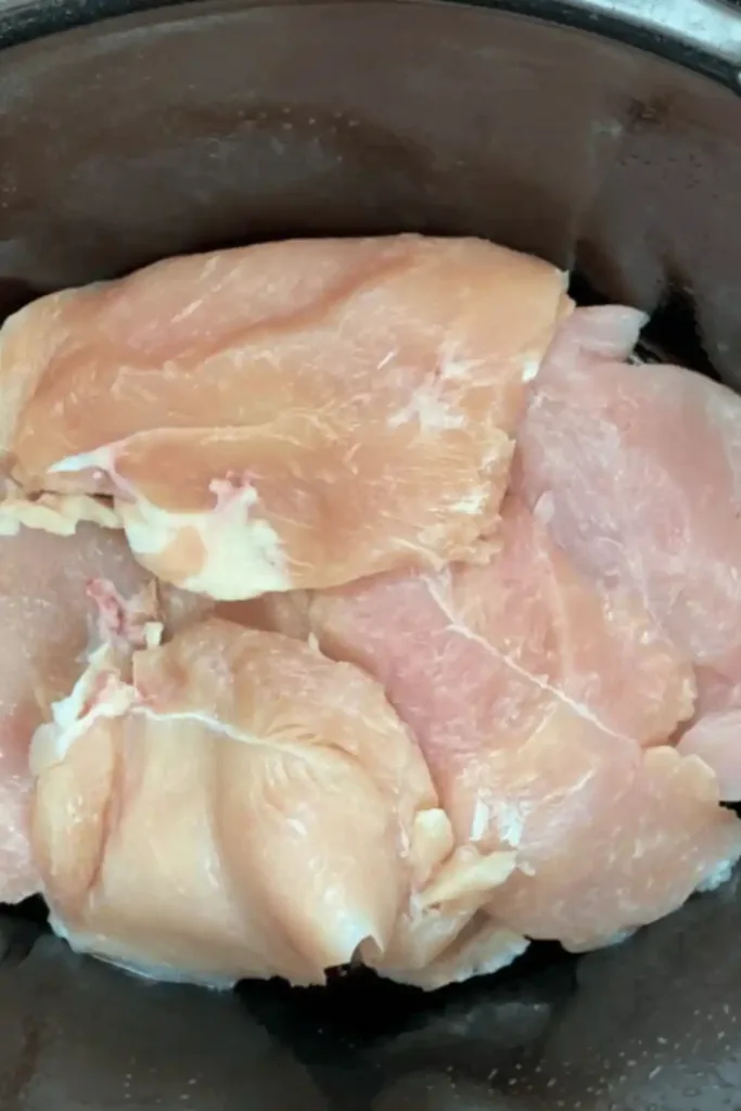 Spraying slow cooker pot with nonstick cooking spray