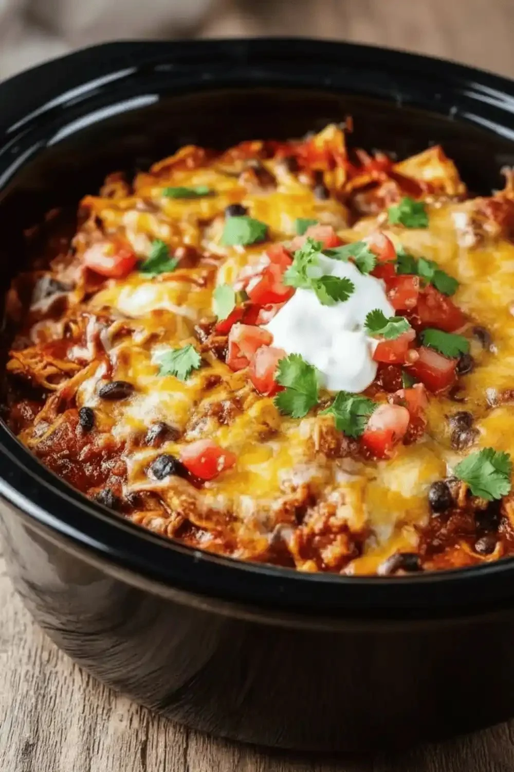 Crockpot Chicken Enchilada Casserole with melted cheese and fresh toppings