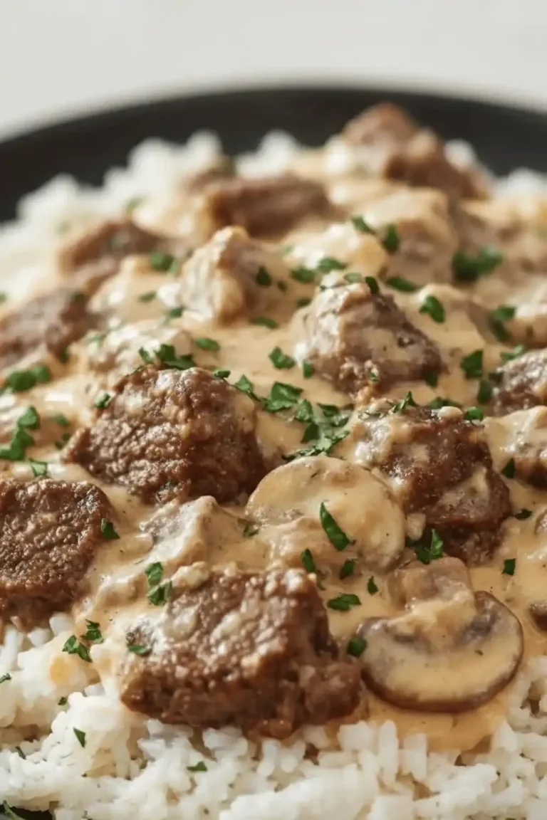 Delicious Steak Cheese Rice served on a plate garnished with herbs.