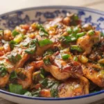Delicious Chinese Scallion Chicken served on a plate with fresh scallions.