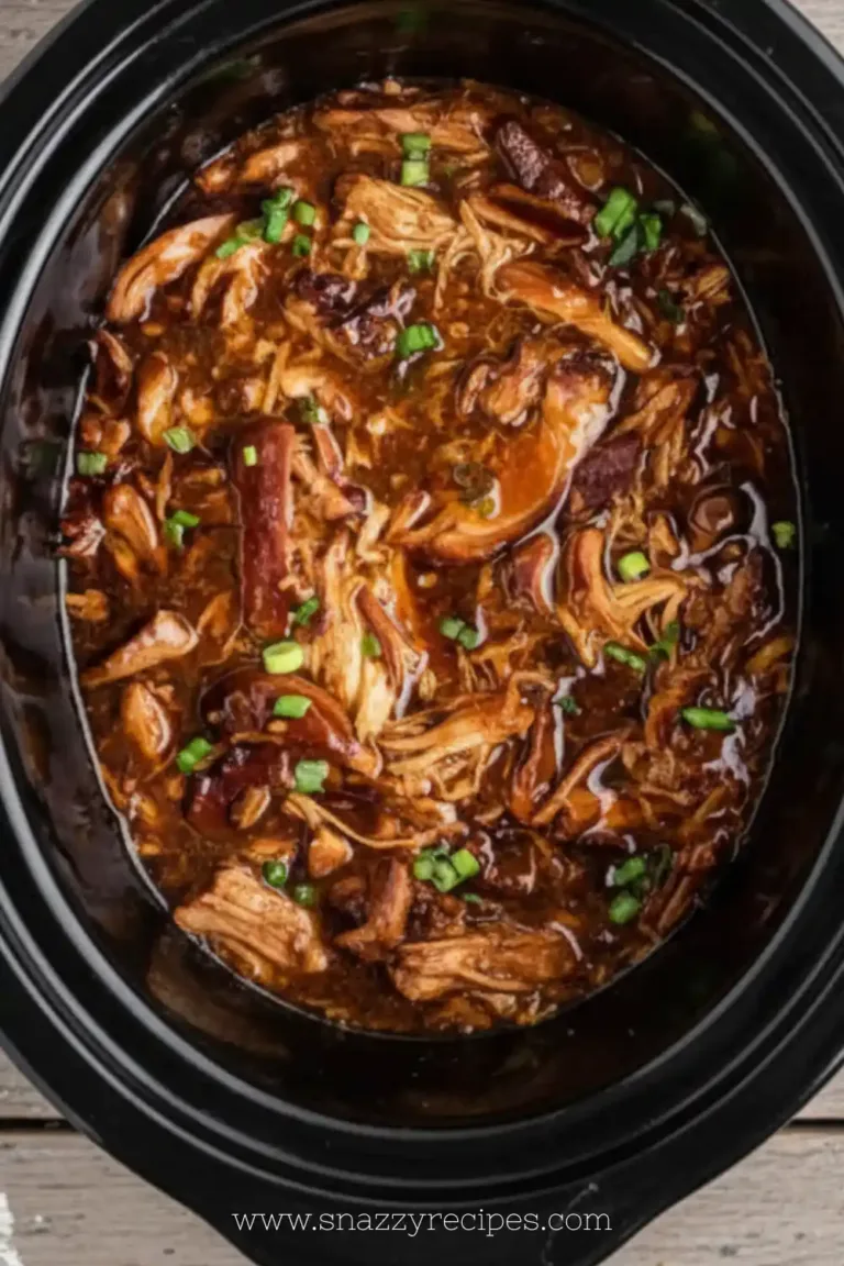 Delicious Crock Pot Bourbon Chicken served on a plate with a side of vegetables.