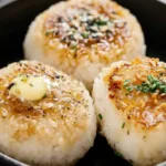Delicious grilled rice balls served on a plate, perfect for snacking.