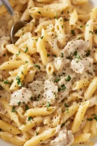 Crockpot Chicken Alfredo dish with creamy sauce and fettuccine pasta