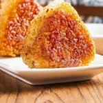 Delicious grilled rice balls garnished with herbs and served on a plate