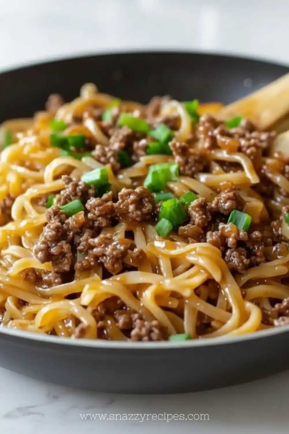Mongolian Ground Beef Noodles served in a bowl with vibrant vegetables.
