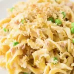 Delicious homemade tuna casserole ready to serve with a sprinkle of herbs.