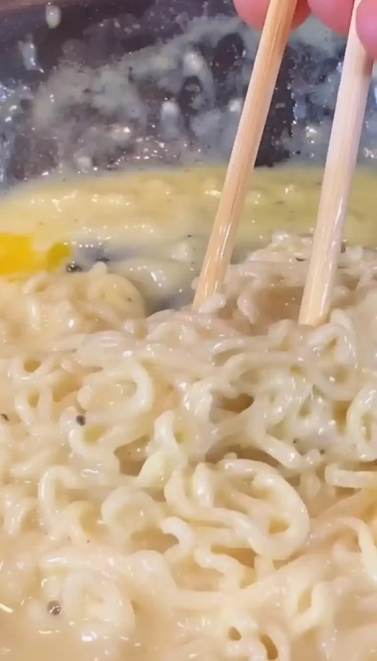 Creamy Garlic Alfredo pasta topped with garlic and parmesan cheese.