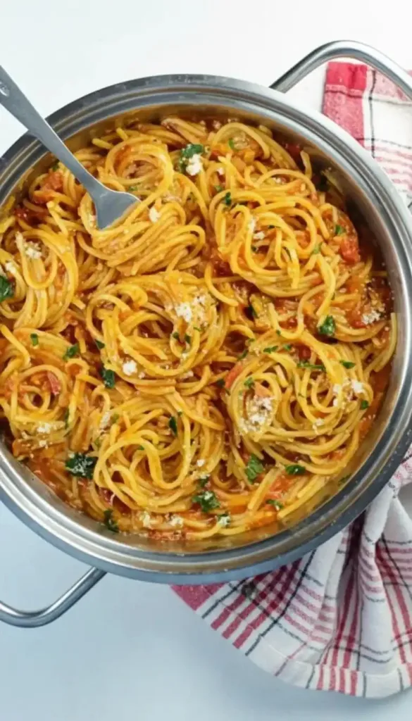 Bowl of One Pot Spaghetti with herbs and Parmesan cheese