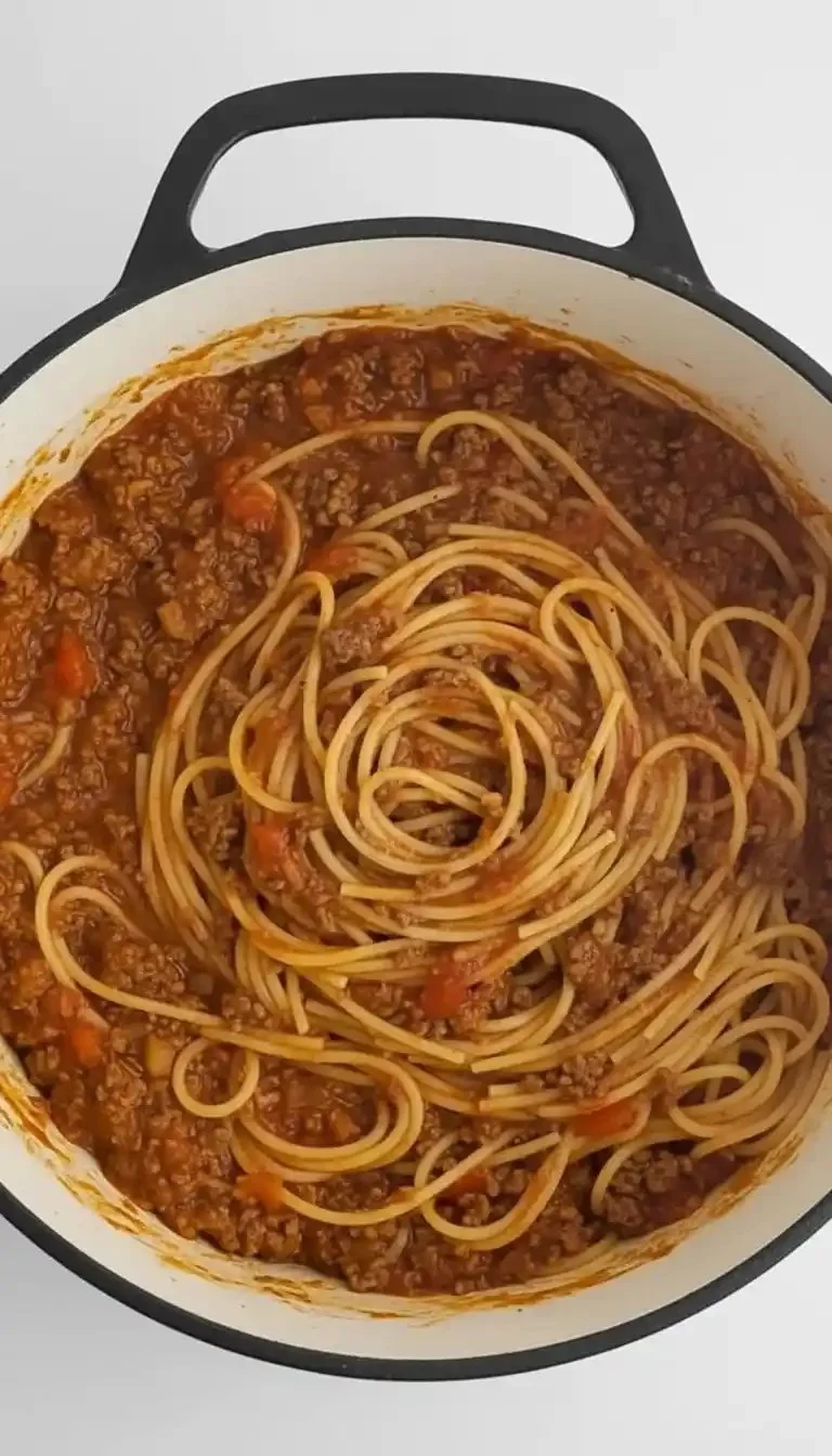 One-Pot Spaghetti with Beef served in a bowl, garnished with parsley.